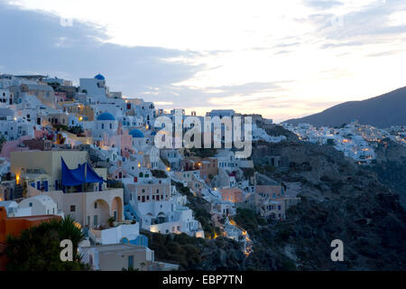 Ia, Santorin, Grèce, sud de la Mer Egée. Village sur la falaise, allumé à l'aube. Banque D'Images