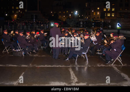 Londres, Royaume-Uni. 4 Décembre, 2014. Le maire de la ville de Westminster et la Conseillère Audrey Lewis Maire d'Oslo, Stian Berger Rosland assister à l'allumage des feux de la décoration de l'arbre de Noël à Trafalgar Square. L'arbre est un don annuel à la population de Londres, dans le peuple d'Oslo en remerciements pour l'appui britannique pendant la Seconde Guerre mondiale. Sur la photo : accès aux bandes de l'Armée du Salut offre accompagnement musical de la Carol chant. Crédit : Paul Davey/Alamy Live News Banque D'Images