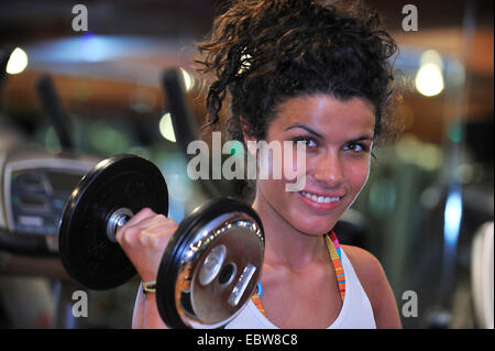 Jolie femme brune l'entraînement avec dumb bell Banque D'Images