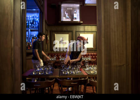 Buenos Aires, Argentine. 9Th Jul 2014. Une serveuse sert whisky pour une restauration dans le Musée du whisky à Buenos Aires, capitale de l'Argentine, le 4 décembre 2014. Le Musée du whisky a été ouverte le 10 novembre, et montre plus de trois mille bouteilles des meilleurs whiskies du monde. En plus de la collection exposée en permanence, le musée possède des chambres et des salles thématiques où les activités pour les membres du club "Whisky malt Argentina' ont lieu, apportant une nouvelle attraction touristique et culturel de la ville de Buenos Aires. © Martin Zabala/Xinhua/Alamy Live News Banque D'Images