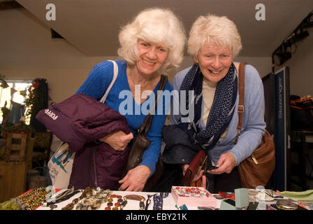 Deux dames âgées parcourant les bijoux décroche à une piscine Marché de Noël, près de Alton, Hampshire, Royaume-Uni. Banque D'Images