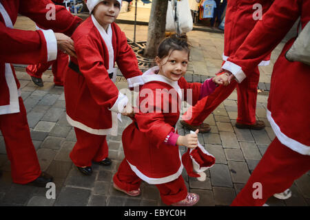 Gibraltar. 5 Décembre, 2014. Gibraltar aujourd'hui vu une longue ligne de Santas se rassemblent à Casemates avant de partir à la rue principale dans une danse Conga. Les clients du soir ont été traités à la danse comme ils Santa conga dirigée à la place avant de se retourner à nouveau de casemates. L'événement faisait partie d'un organisme de bienfaisance exécuter organisé par le Rotary Club, et aidé par la bande de Calpe. Crédit : Stephen Ignacio/Alamy Live News Banque D'Images