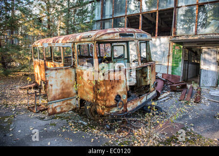 Dans l'épave du bus de l'usine abandonnée Pripyat Jupiter en ville, zone d'exclusion de Tchernobyl, l'Ukraine Banque D'Images