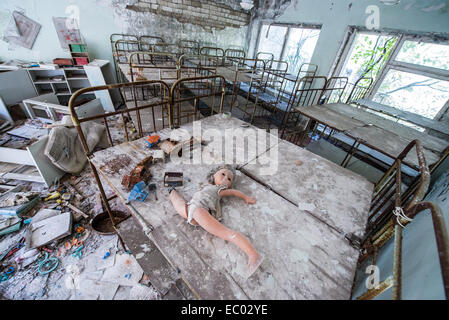 Poupée ancienne en maternelle "Cheburashka' dans la ville abandonnée Pripyat, zone d'exclusion de Tchernobyl, l'Ukraine Banque D'Images