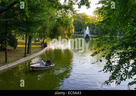 Les gens de bateau sur le lac au jardins Cismigiu dans le centre de Bucarest, Roumanie. Banque D'Images