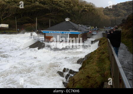 De grosses vagues se briser sur la mer tourbillonnant autour de la défense Surfside Cafe sur Caswell Bay volets rupture préjudiciable à l'intérieur Banque D'Images