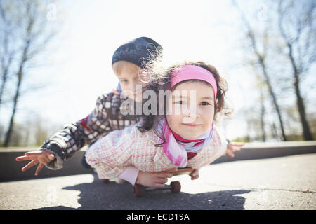 Jolie fille et garçon skaiting sur rue Banque D'Images