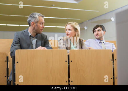 Perplexe businesspeople sitting in auditorium Banque D'Images