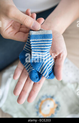 Close-up femme hands holding Baby socks Banque D'Images