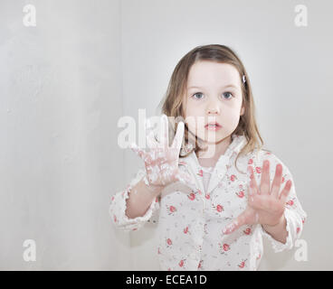 Fille avec de la peinture sur les mains humides Banque D'Images