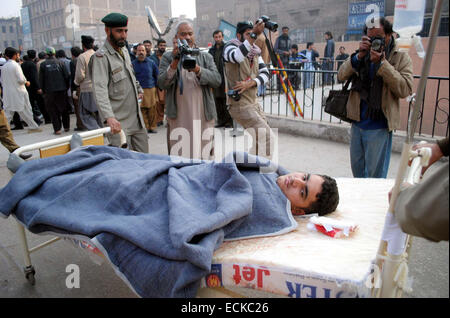 Peshawar, Pakistan. Dec 16, 2014. Victimes de militants ont attaqué une école publique de l'armée situé sur la route de Warsak, on passe d'un traitement à l'hôpital local de Peshawar. Plus d'une centaine de personnes pour la plupart des étudiants ont été tués et des dizaines d'autres blessés lorsque l'Armée de militants ont attaqué une école publique située sur la route de Warsak à Peshawar. Cinq ou six militants portant des uniformes militaires entre dans l'armée à l'école publique dans la ville de Peshawar. Les troupes ont encerclé la zone et (sont) à la recherche d'les militants. Credit : Asianet-Pakistan/Alamy Live News Banque D'Images