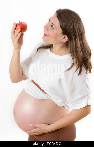 Pregnant Woman holding an apple isolated on white Banque D'Images