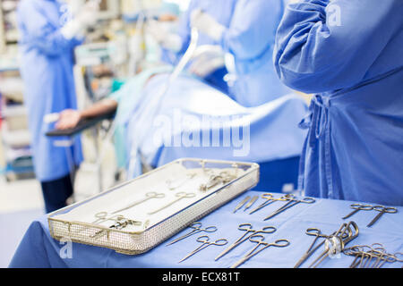 Nurse standing par bac avec outils en salle d'opération chirurgicale Banque D'Images