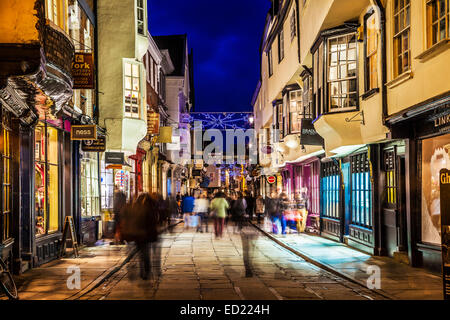 Les acheteurs de Noël se hâtait le long de la rue historique de Stonegate à York au crépuscule. Banque D'Images