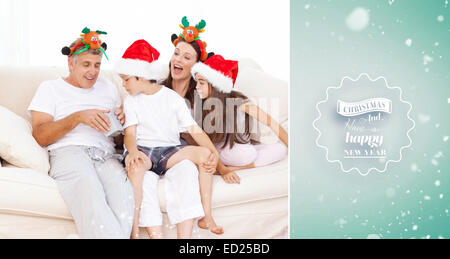 Image composite de famille le jour de Noël à regarder leur présente à la maison Banque D'Images