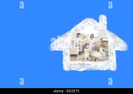 Image composite de family unpacking cardboard box Banque D'Images