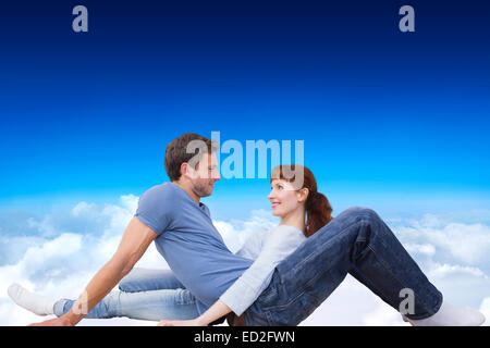 Image composite de couple assis sur le plancher Banque D'Images