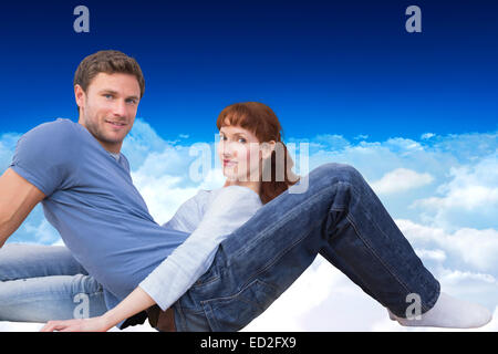 Image composite de couple assis sur le plancher Banque D'Images