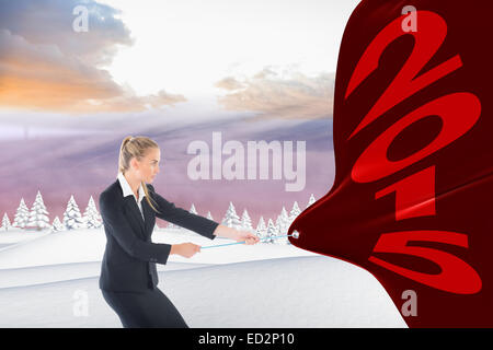 Composite image of blond businesswoman pulling a rope Banque D'Images