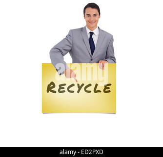 Image composite de goodlooking man holding et en montrant un grand poster Banque D'Images