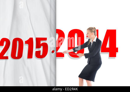 Composite image of blond businesswoman pulling a rope Banque D'Images