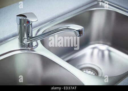 Close up shot pour le nettoyage du robinet chromé et lavabo dans une cuisine Banque D'Images