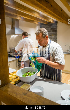 Deux hommes chefs préparer préparer un repas dans une cuisine moderne, UK Banque D'Images