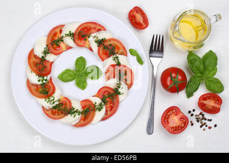 Salade Caprese avec tomates et mozzarella de dessus sur une planche en bois Banque D'Images