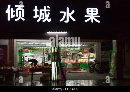 Hangzhou, Chine - 3 décembre 2014 : marché de l'alimentation traditionnelle chinoise avec des légumes et des néons de la publicité sur le mur Banque D'Images