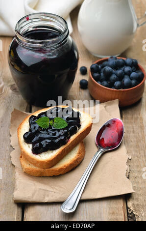 Confiture sur des toasts de pain sur table en bois Banque D'Images