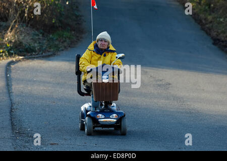 Woman riding scooter médical motorisé sur route : Victoria, British Columbia, Canada. Banque D'Images