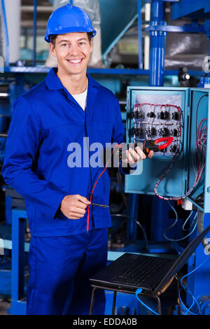 Beau mâle technician holding testeur d'isolement numérique Banque D'Images