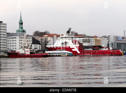 La plate-forme de forage d'ancres loin du navire remorqueur et Scorpion Boa Odin avec petit ferry port de Bergen, en Norvège Banque D'Images