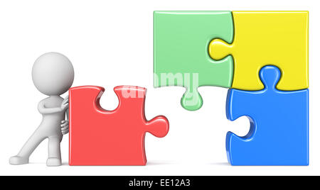 Le mec en poussant dernier morceau de grand puzzle coloré. Banque D'Images