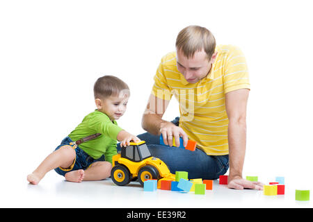 Bébé garçon et son père la réparation du tracteur jouet Banque D'Images