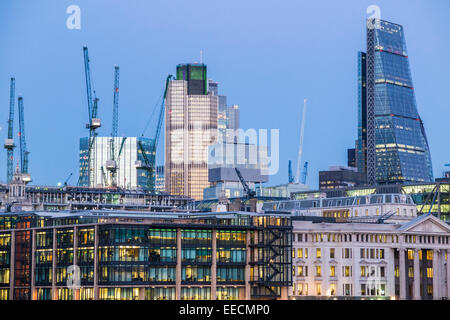 Grues à tour sur le site de Bloomberg, Ville de London EC4, Cheesegrater, nouvelle Cour et Tour 42 en lumière du soir Banque D'Images