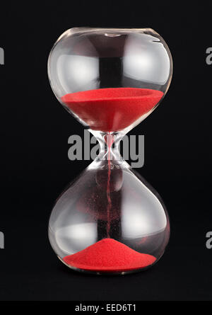 Sable rouge avec Hourglass fonctionnant par les bulbes Banque D'Images