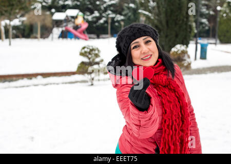 Les femmes turques aux cheveux noirs tenant un cœur rouge dans sa main.le jour de Valentine avec arrière-plan de neige Banque D'Images