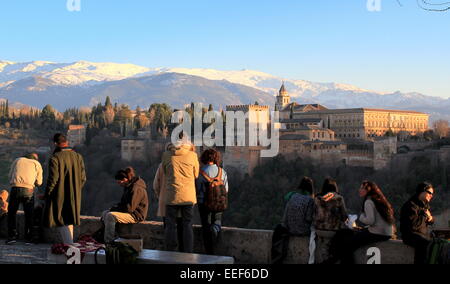 Les touristes sur l'Albaicín hill admirer la forteresse de l'Alhambra et Grenade, en Espagne, avec la Sierra Nevada en arrière-plan Banque D'Images