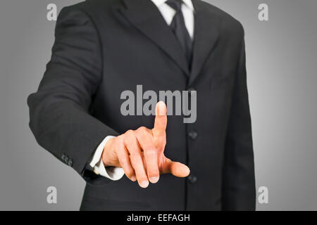 Businessman cliquant sur écran tactile Banque D'Images