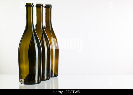 Trois bouteilles de vin sur une table en verre Banque D'Images