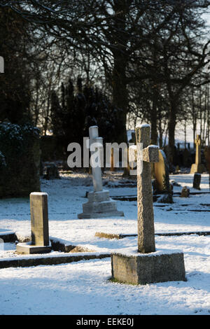 Pierre tombale Croix dans la neige dans un cimetière. Arles, France Banque D'Images