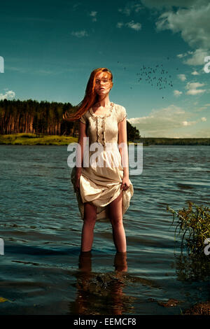 Caucasian woman standing in remote lake