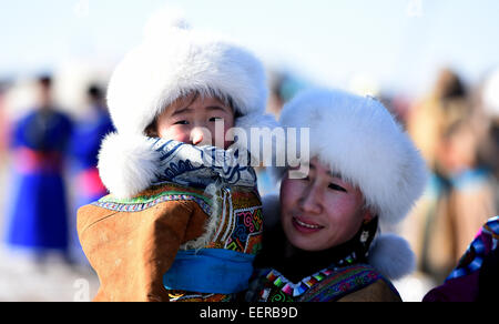 Bannière Ujimqin l'Est de la Chine, région autonome de Mongolie intérieure. 21 Jan, 2015. Une femme prend son enfant à un hiver au Nadam Bannière Ujimqin, Chine du nord, région autonome de Mongolie intérieure, le 21 janvier 2015. Nadam de masse est un festival mongol traditionnel où les gens célébrer les récoltes et prier pour la bonne chance. © Ren Junchuan/Xinhua/Alamy Live News Banque D'Images