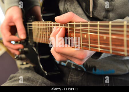 Jouant sur le manche de guitare sur une guitare électrique Banque D'Images