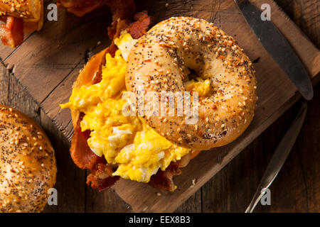 Petit-déjeuner copieux sur un bagel Sandwich aux oeufs bacon et fromage Banque D'Images