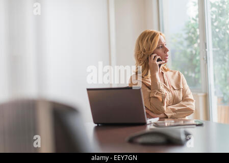 Business Woman using phone in office Banque D'Images