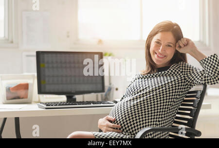 Portrait of pregnant woman in office