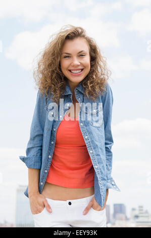 Portrait of young woman wearing denim shirt Banque D'Images