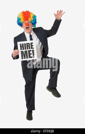 Businessman wearing clown nose et perruque Banque D'Images